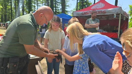 Families and visitors enjoying stalls and activities at High Wood Summer Fair.