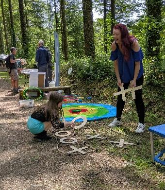 A busy scene from High Wood Summer Fair with visitors and volunteers.