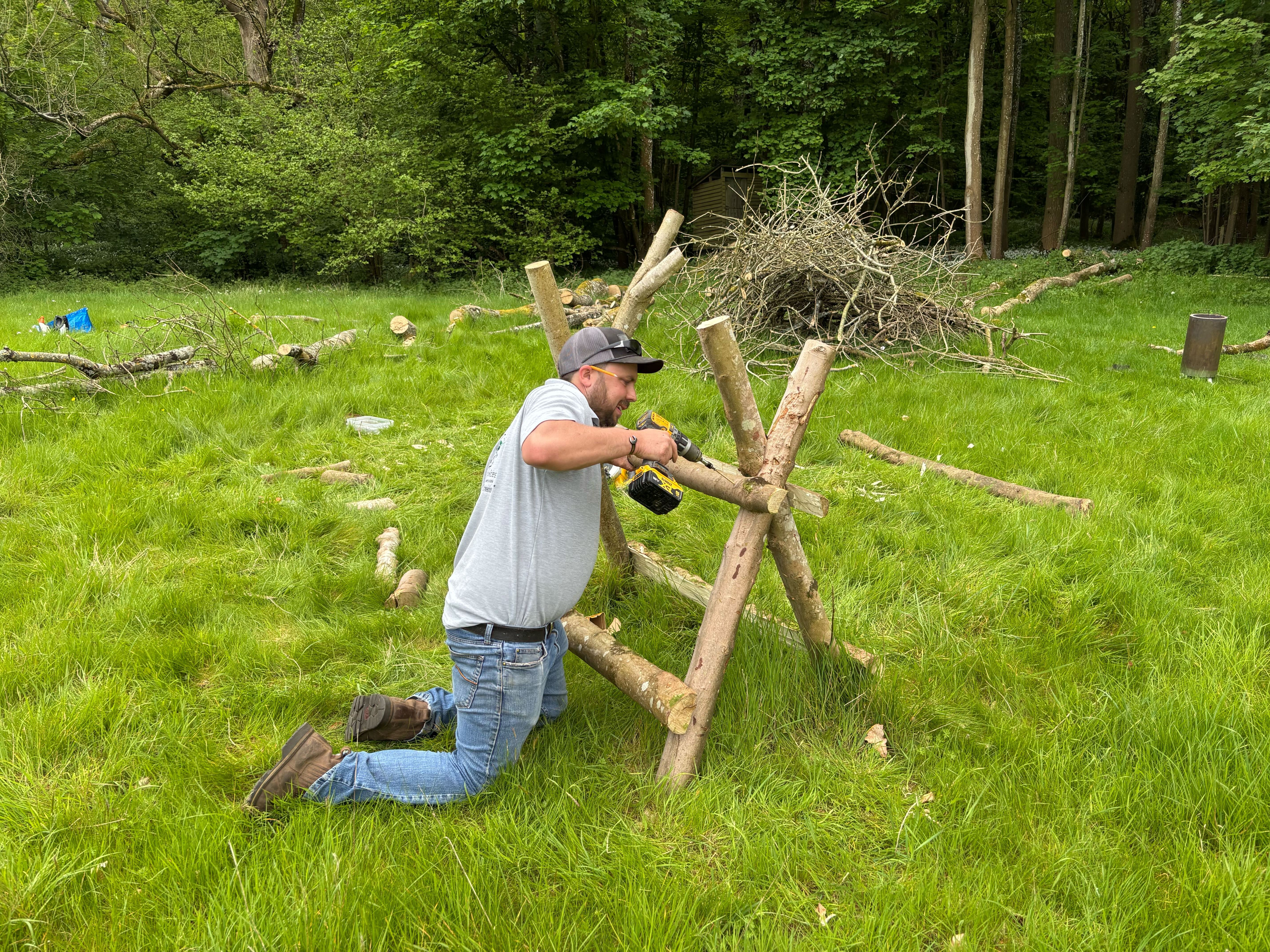 Man building a saw horse using coppiced hazel wood instead of store bought treated timber